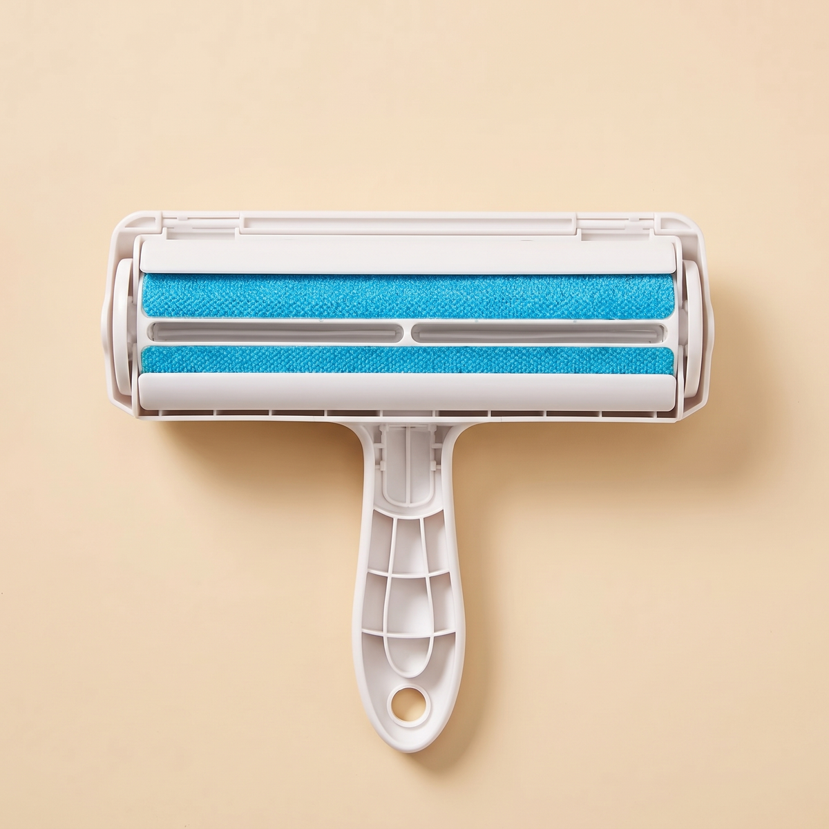 White pet hair remover roller with two blue brush strips on a plain cream background