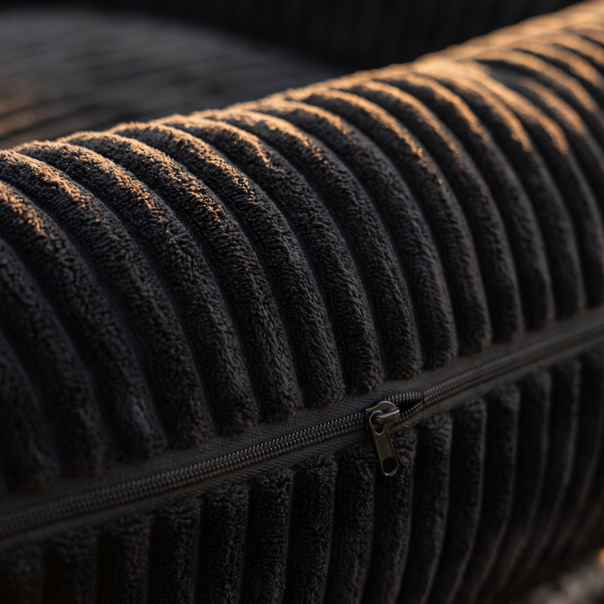 Close-up of the ribbed corduroy plush bolster and washable cover zip