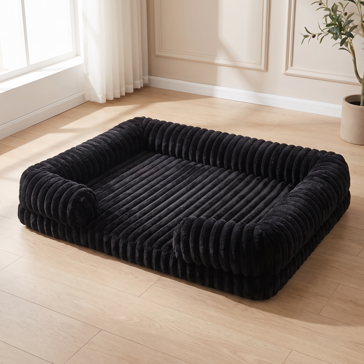 Black ribbed corduroy orthopedic dog sofa bed on a pale oak floor