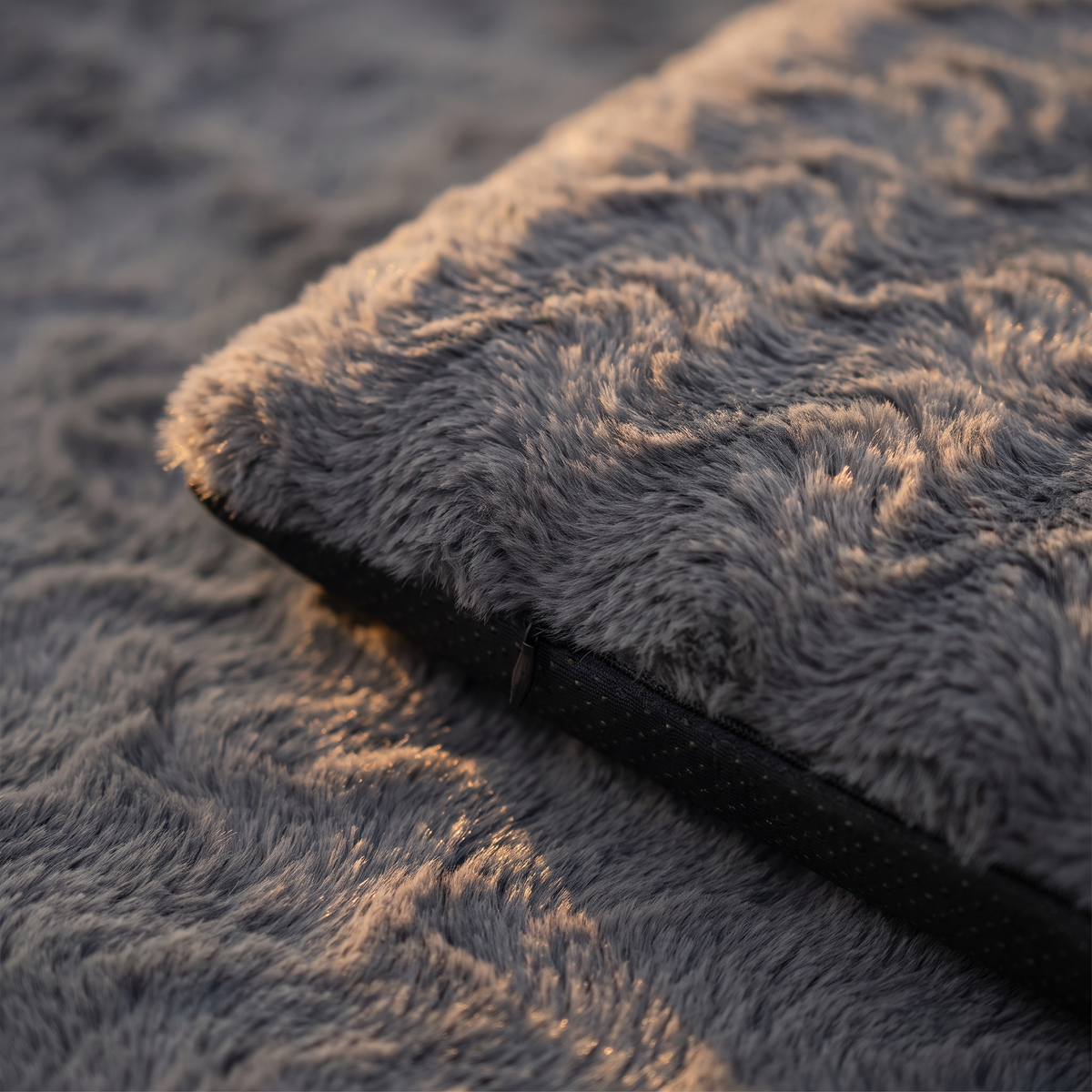 Close-up of the swirled faux fur top and waterproof base of the crate mattress