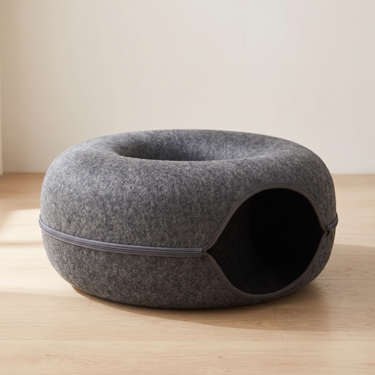 Dark grey felt donut cat bed with tunnel on oak floor