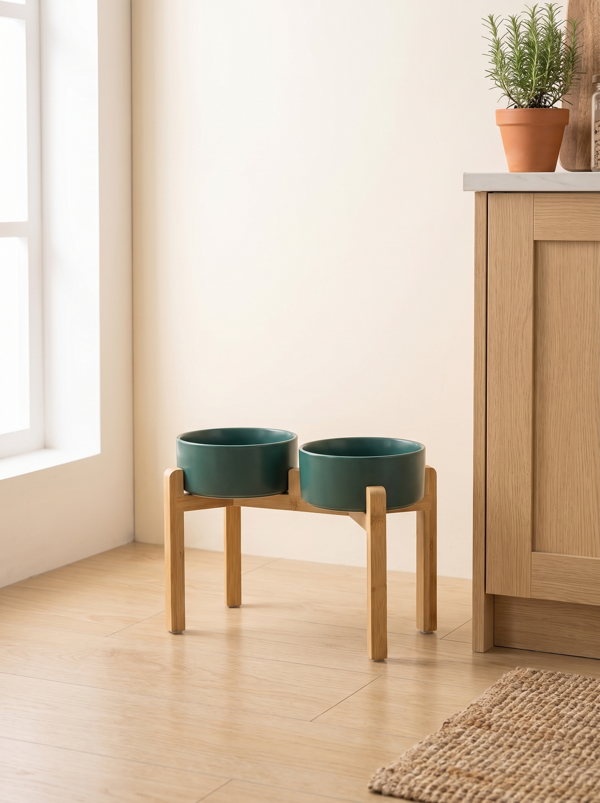 K02B Raised double teal ceramic dog bowl station on the floor of a warm oak kitchen