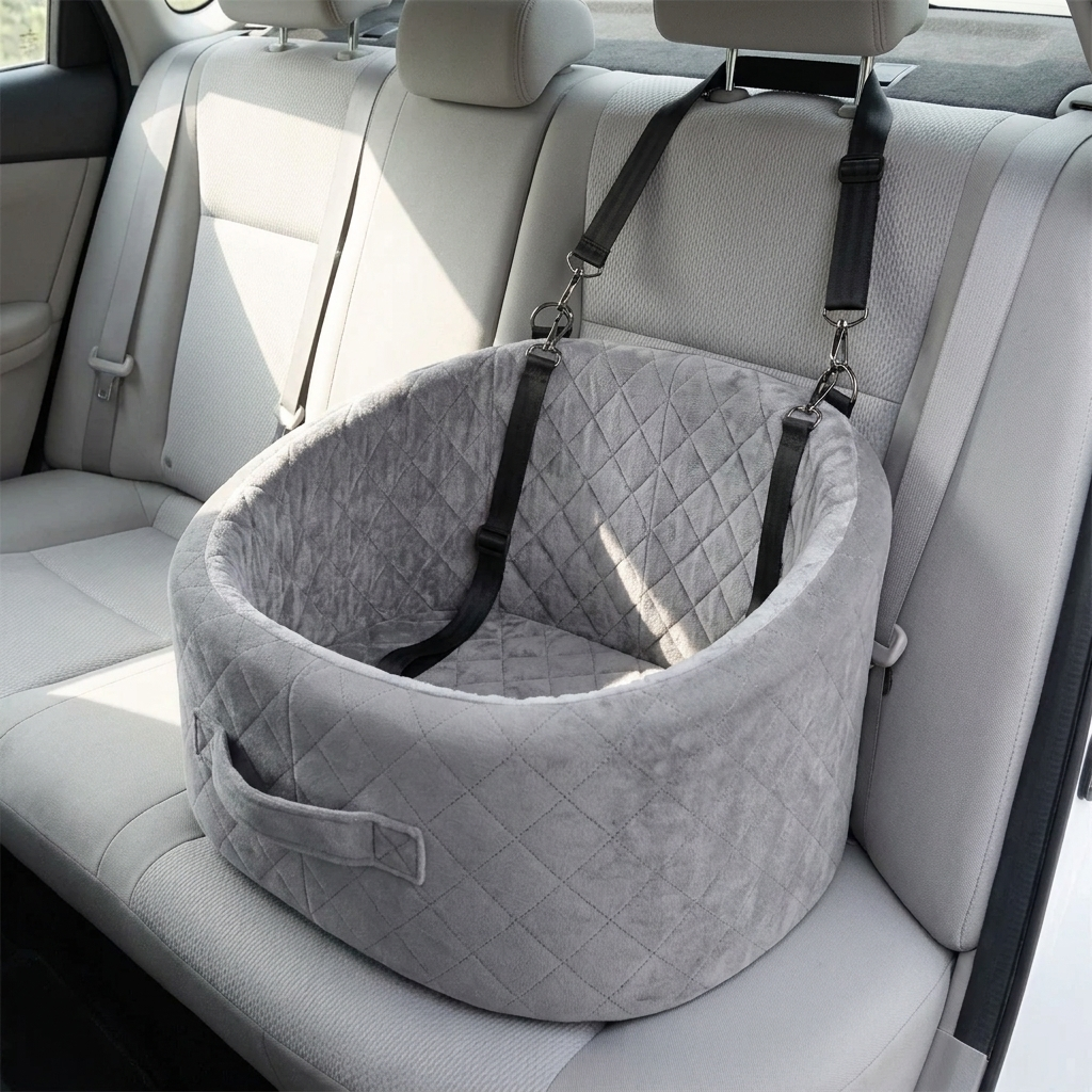 Grey quilted pet car booster seat strapped to the rear seat of a car