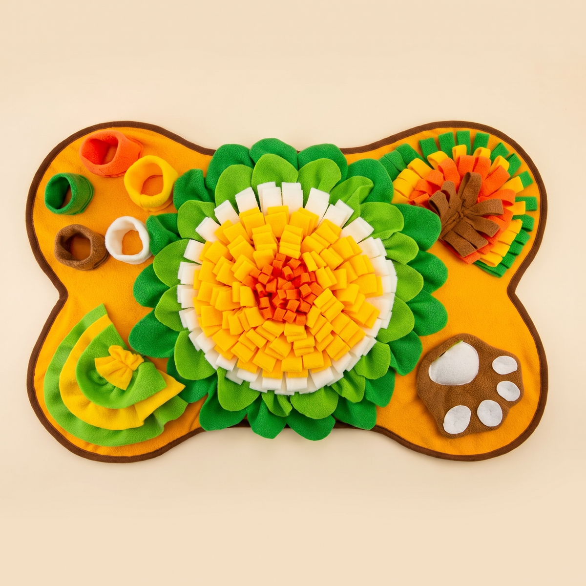 Bone shaped fleece snuffle mat with sunflower, pockets and paw print seen from above on a cream background
