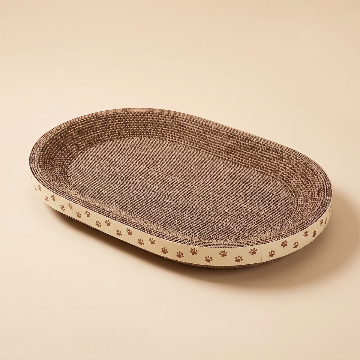 Oval cardboard cat scratcher lounge bed on a plain cream background
