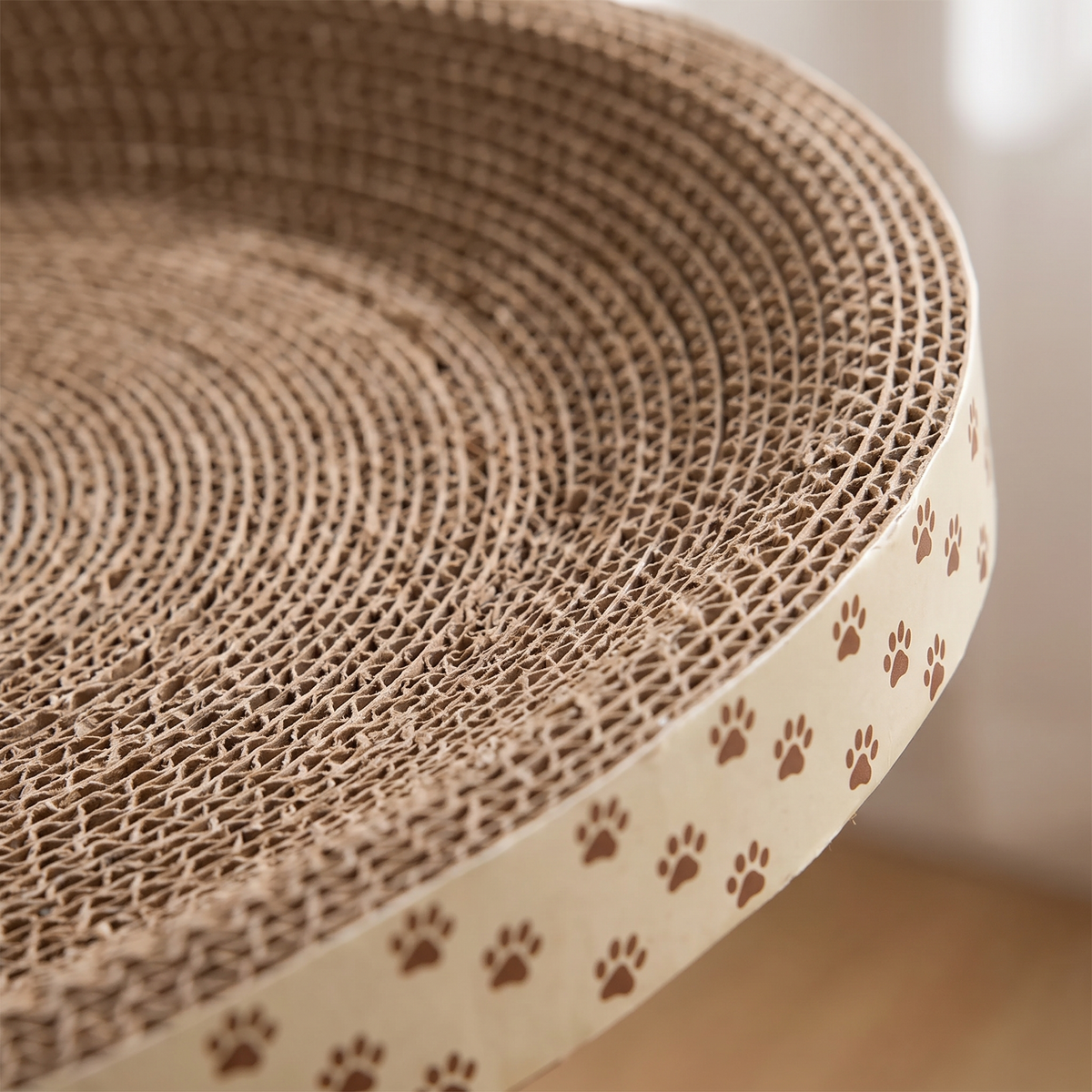 Close-up of the corrugated cardboard layers and paw print band on the cat scratcher