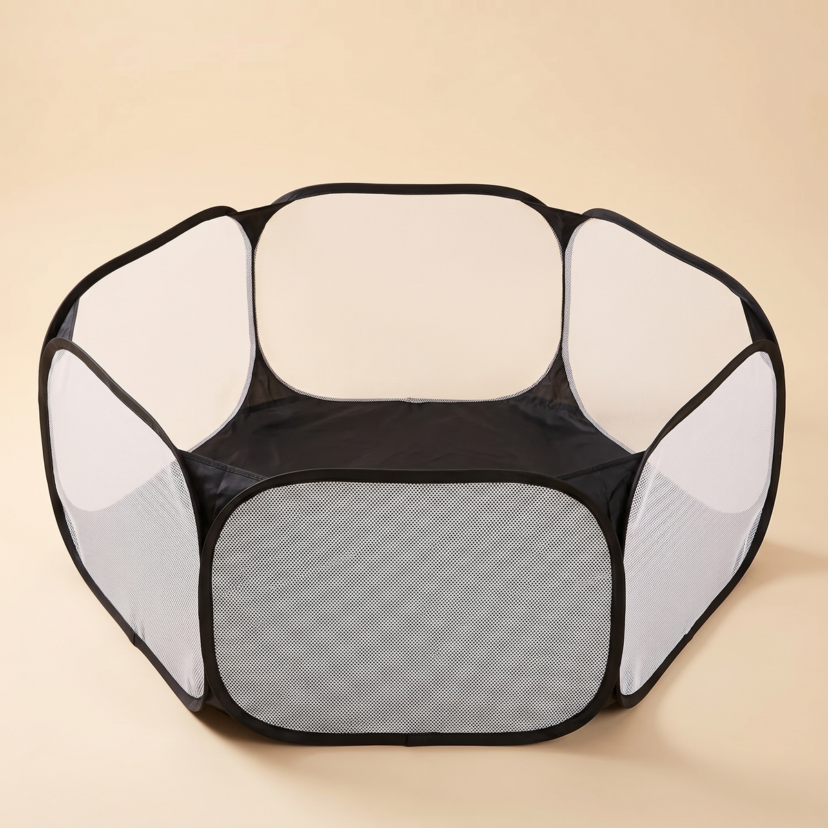 Black six panel pop up mesh pet playpen on a plain cream background