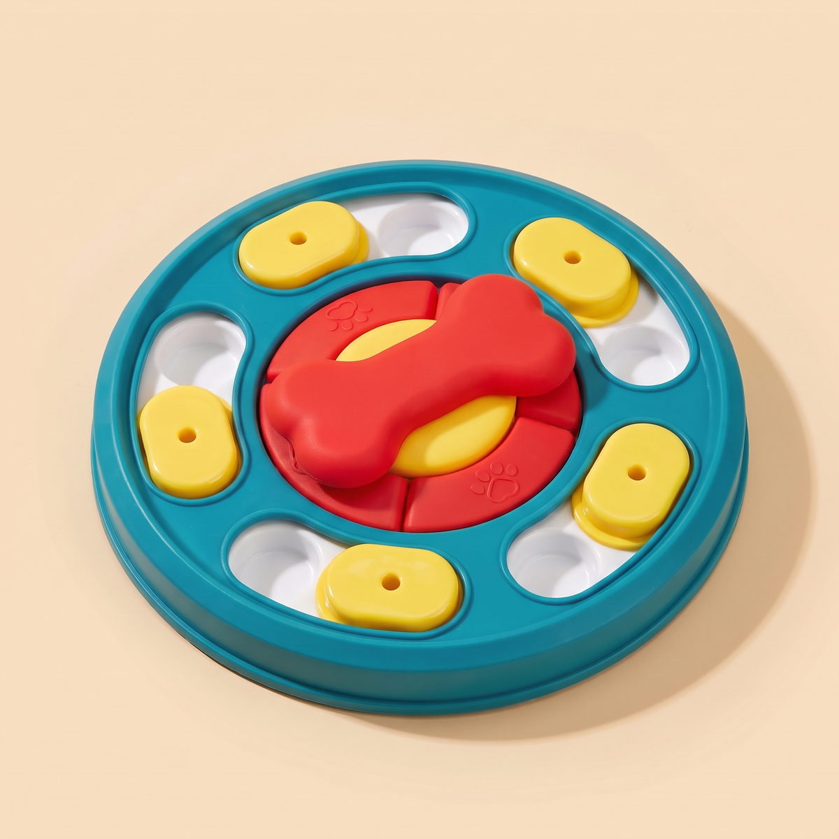 Teal, yellow and red dog puzzle feeder toy on a plain cream background