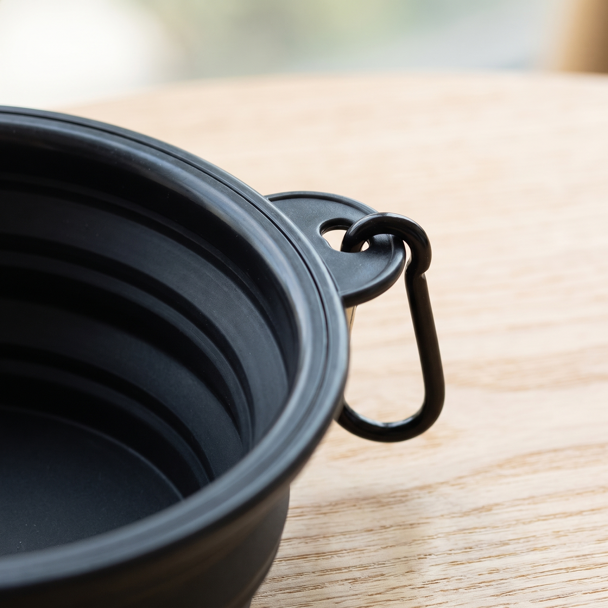 Close-up of the carabiner clip and stepped silicone wall of a collapsible dog bowl
