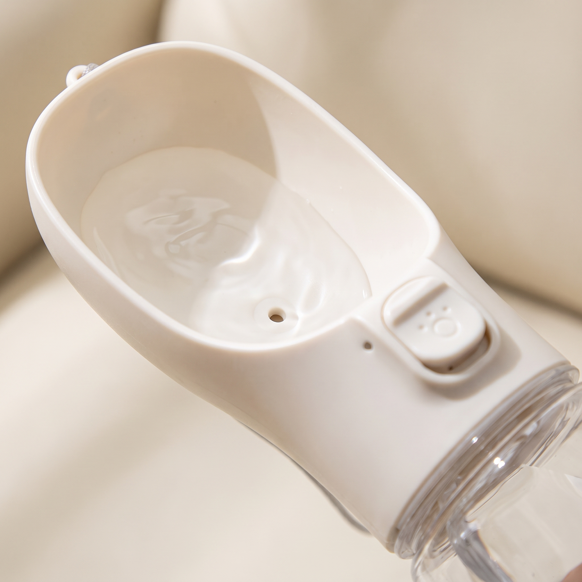 Close-up of the drinking trough and lock button on a portable dog water bottle