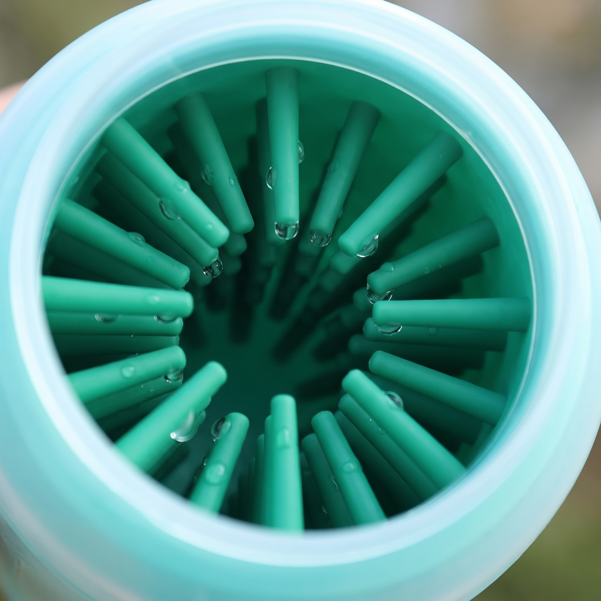 Close-up looking into the soft silicone bristles of a dog paw cleaner cup