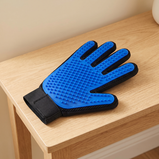 Blue silicone pet grooming glove lying palm up on an oak console table