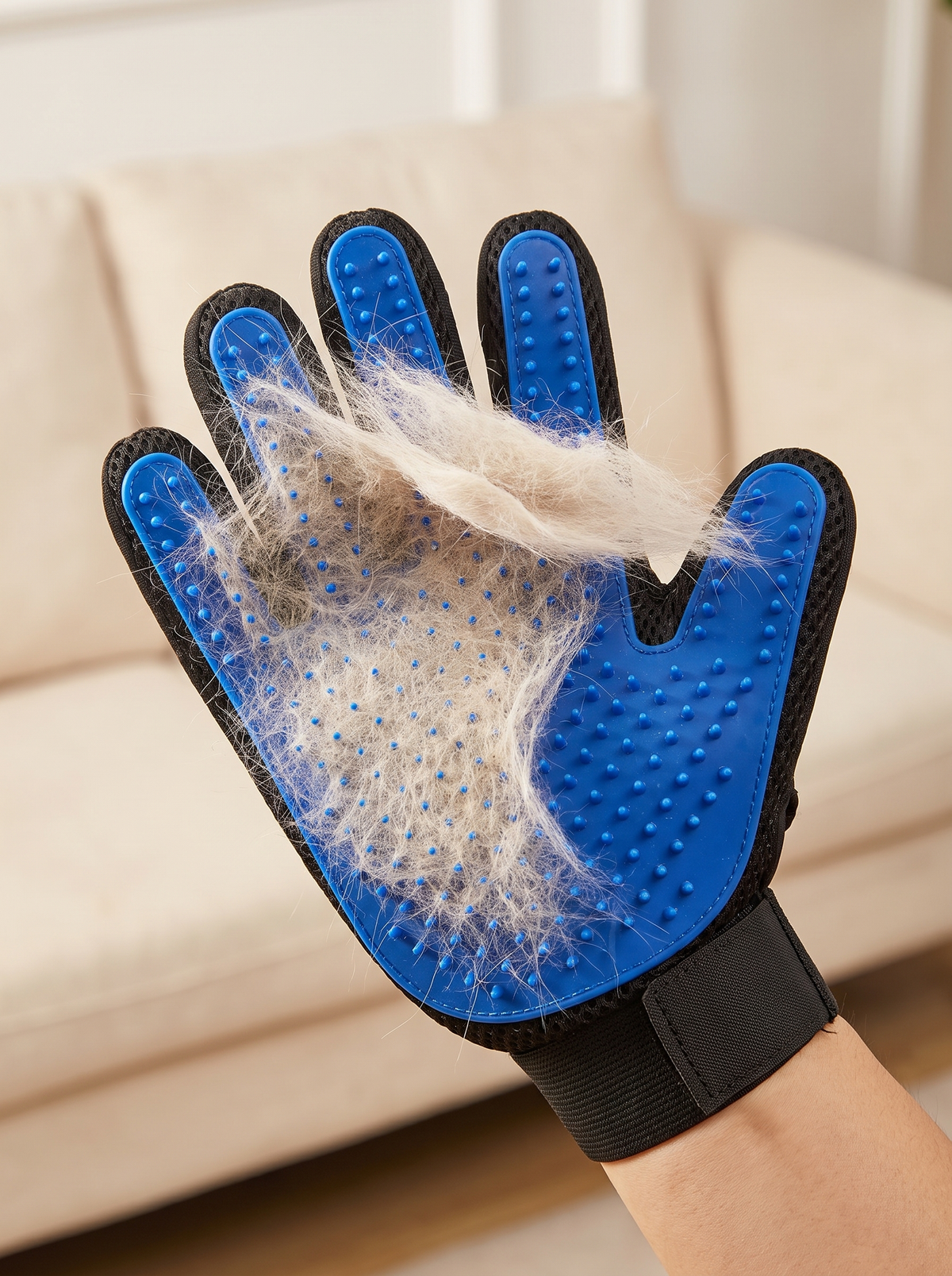Sheet of collected pet fur peeling off a blue grooming glove