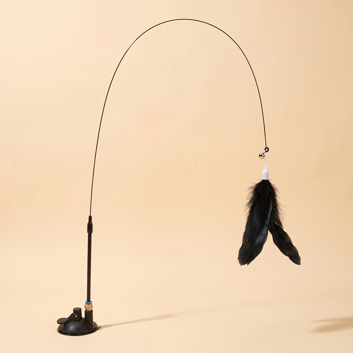 Suction cup cat feather wand with flexible steel wire on a cream background