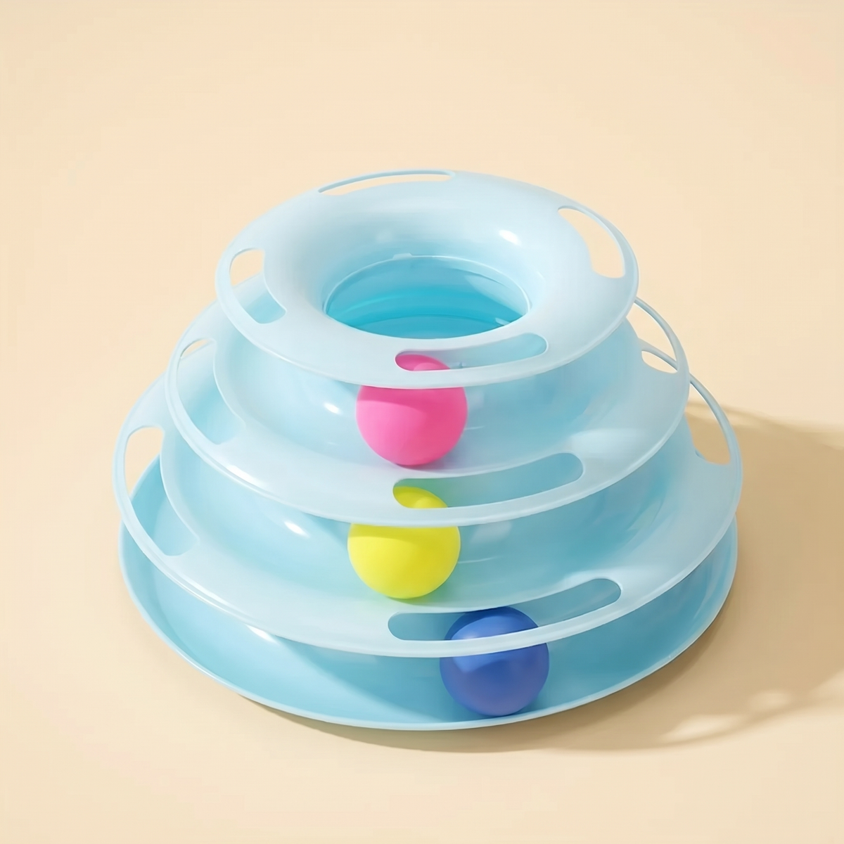 Blue 3 tier cat ball track tower with three balls on a cream background