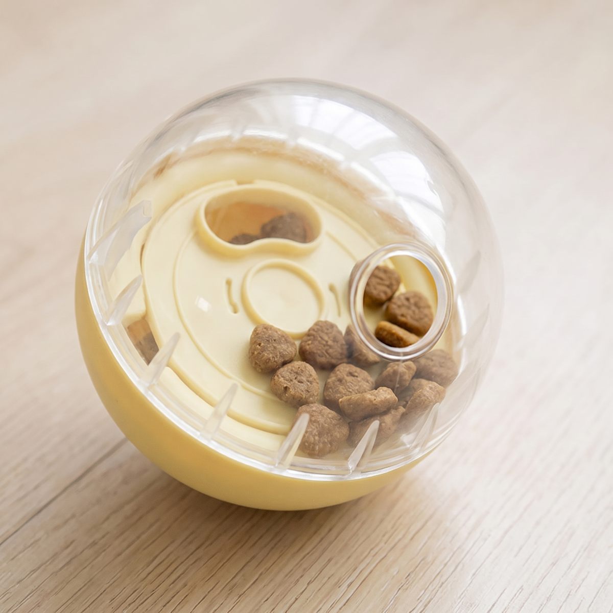 Close-up of kibble inside the clear top of a dog treat dispensing ball