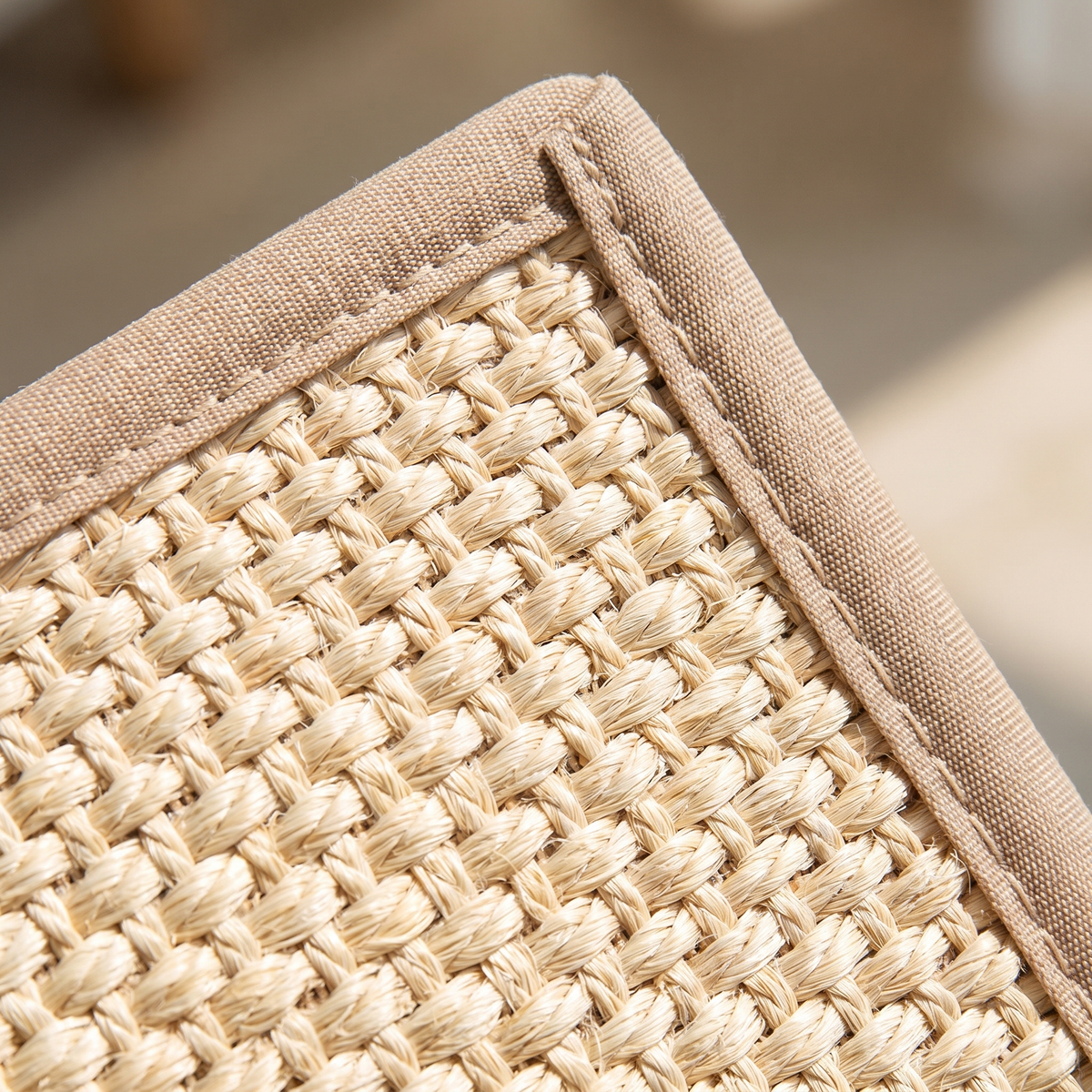 Close-up of the woven sisal and stitched bound edge of a cat scratching mat