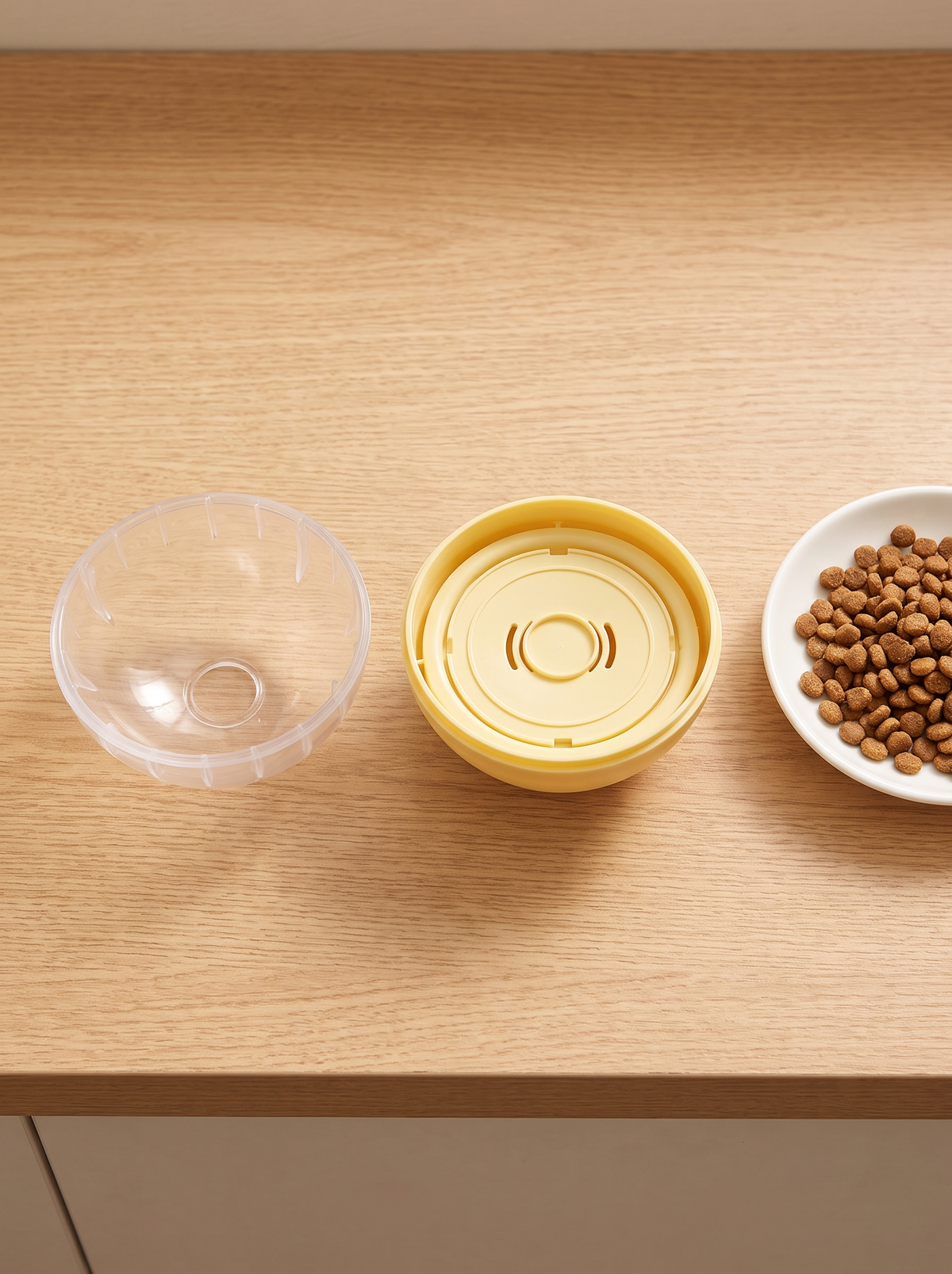 Treat dispensing ball opened into two halves beside a dish of kibble