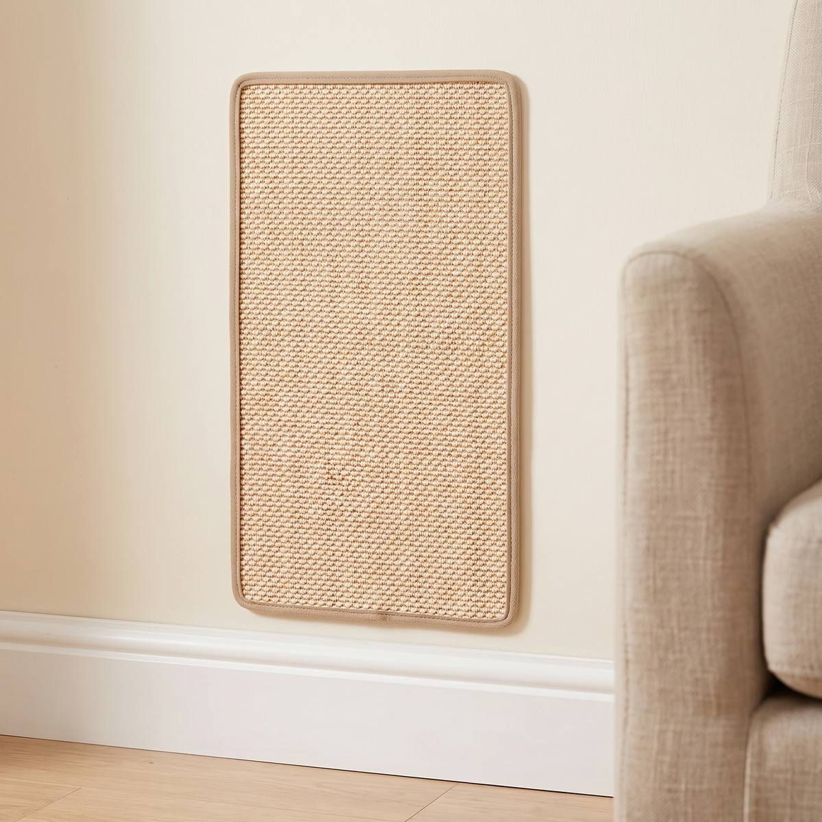 Sisal cat scratching mat fixed to a cream wall in a living room