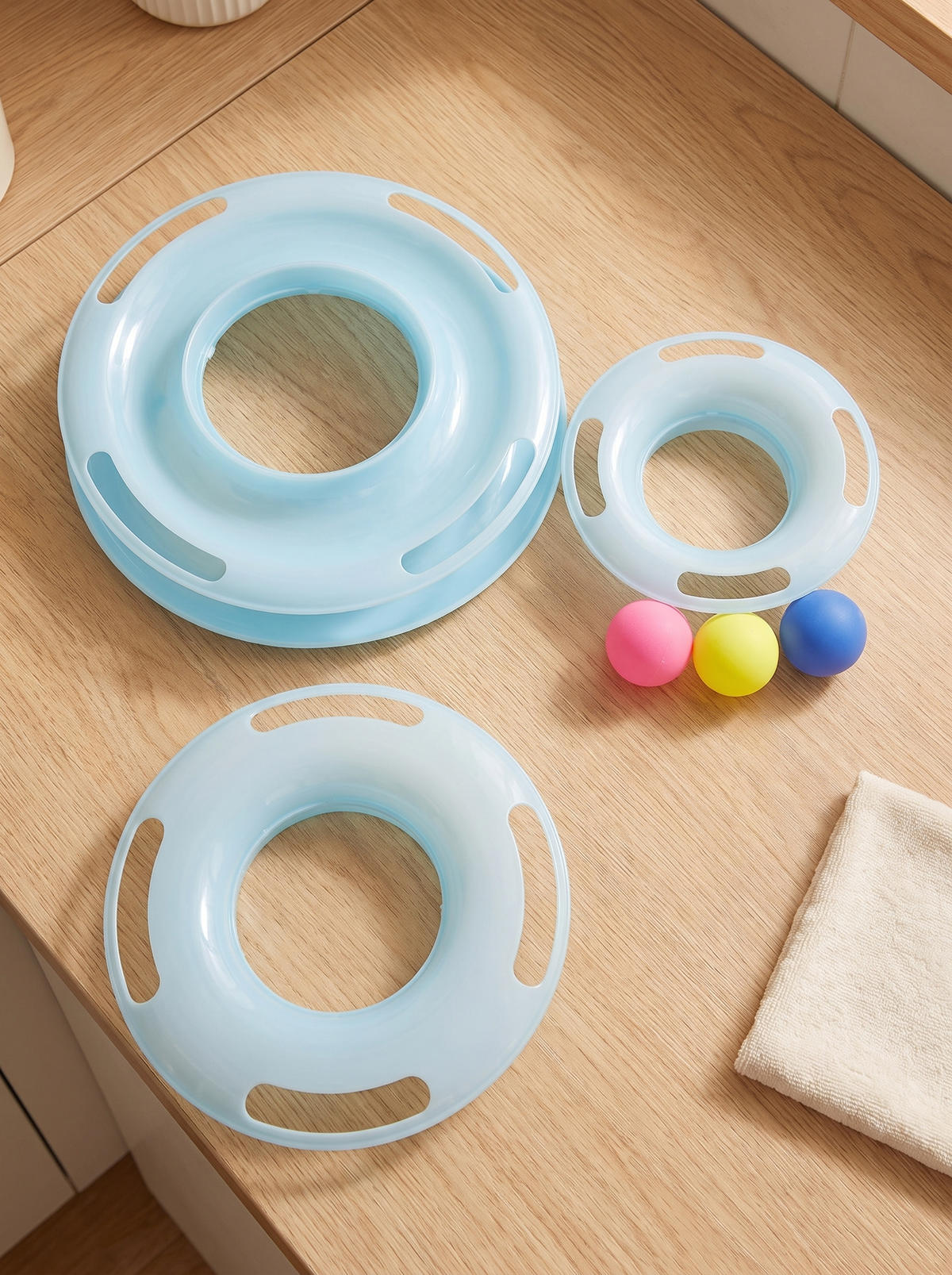 Cat ball track tower taken apart into three rings and three balls for cleaning