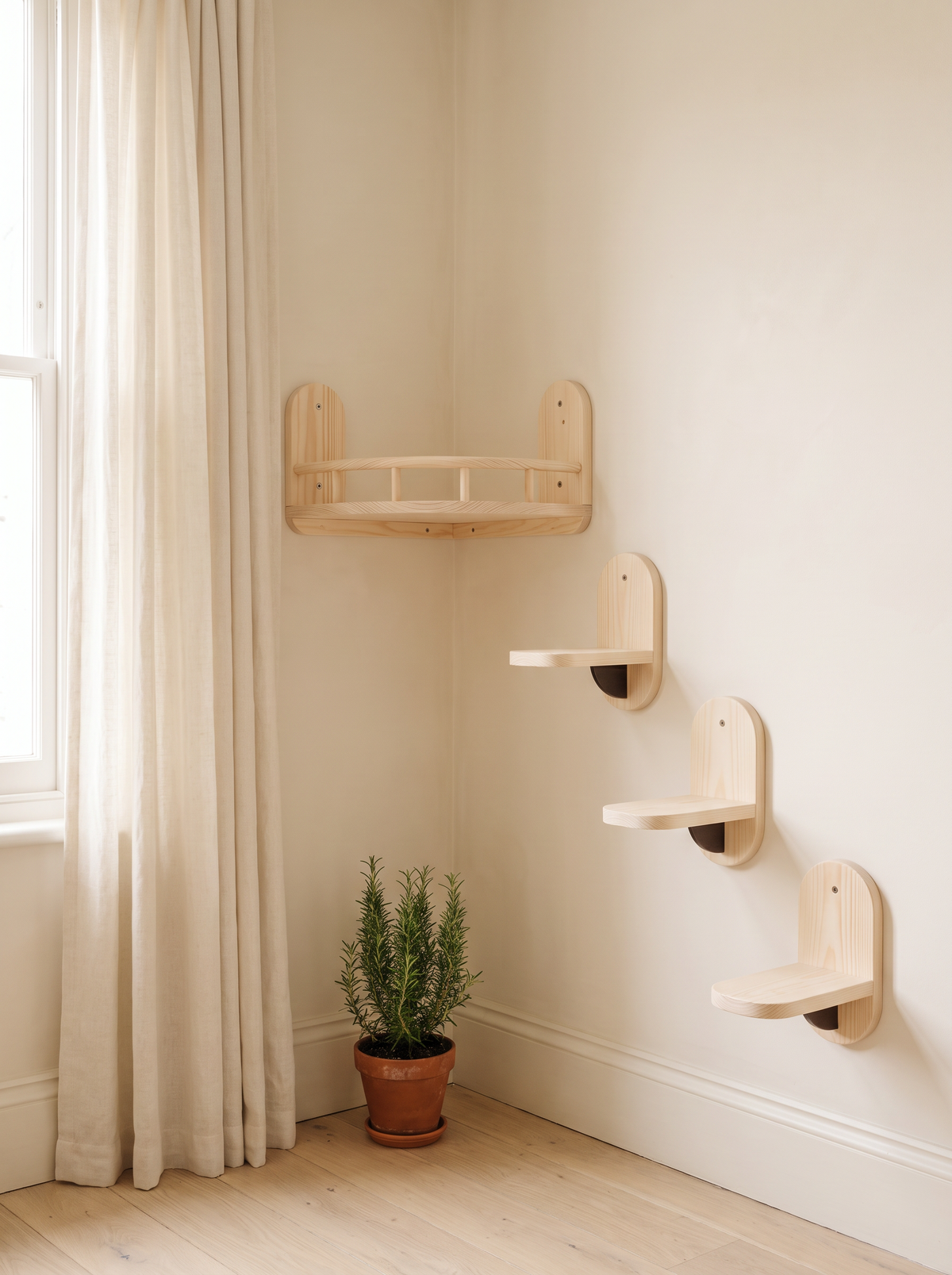 Pale pine corner cat shelf and three climbing steps in a bright room corner by a window