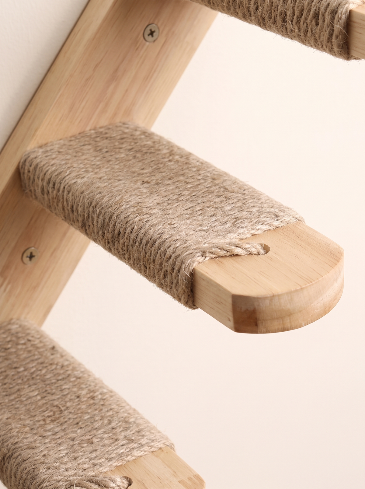 Close-up of a sisal wrapped cat step with rounded pale pine nose on its back rail